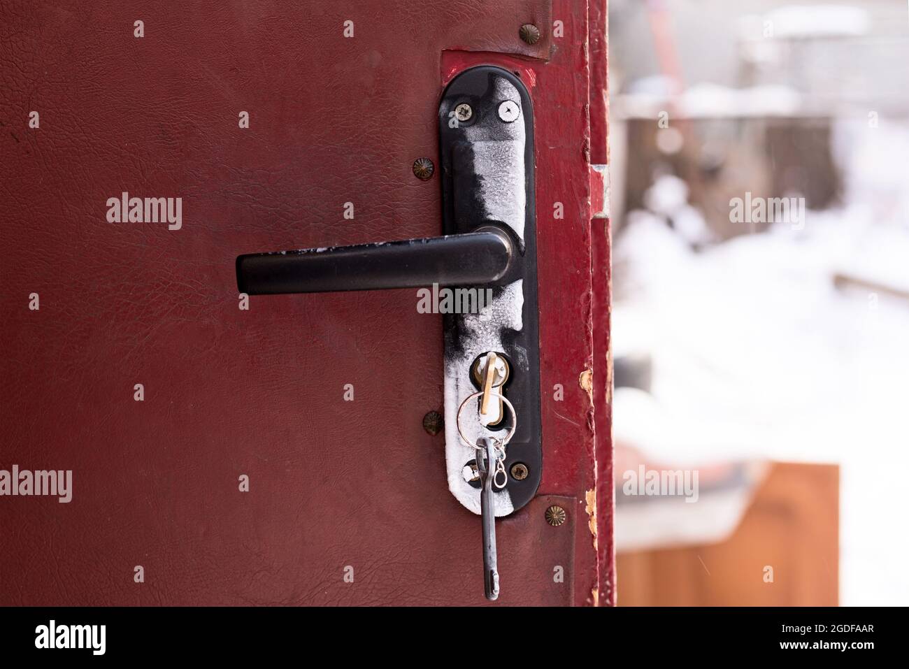 Frozen door lock on old brown doors Stock Photo - Alamy