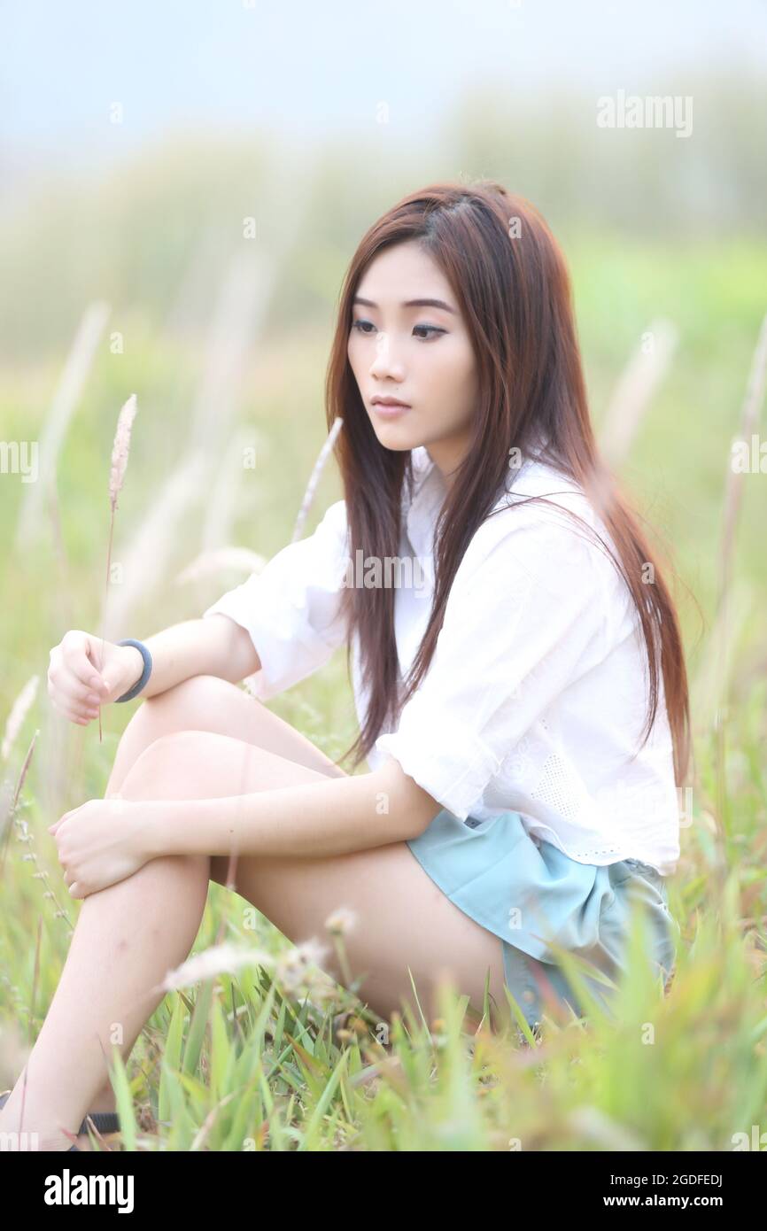 Asian girl on wheat field Stock Photo - Alamy