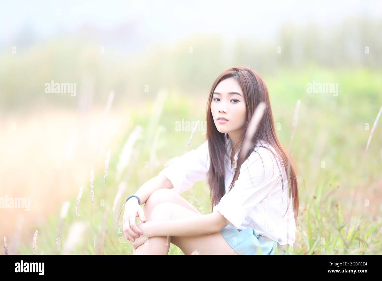 Asian girl on wheat field Stock Photo - Alamy