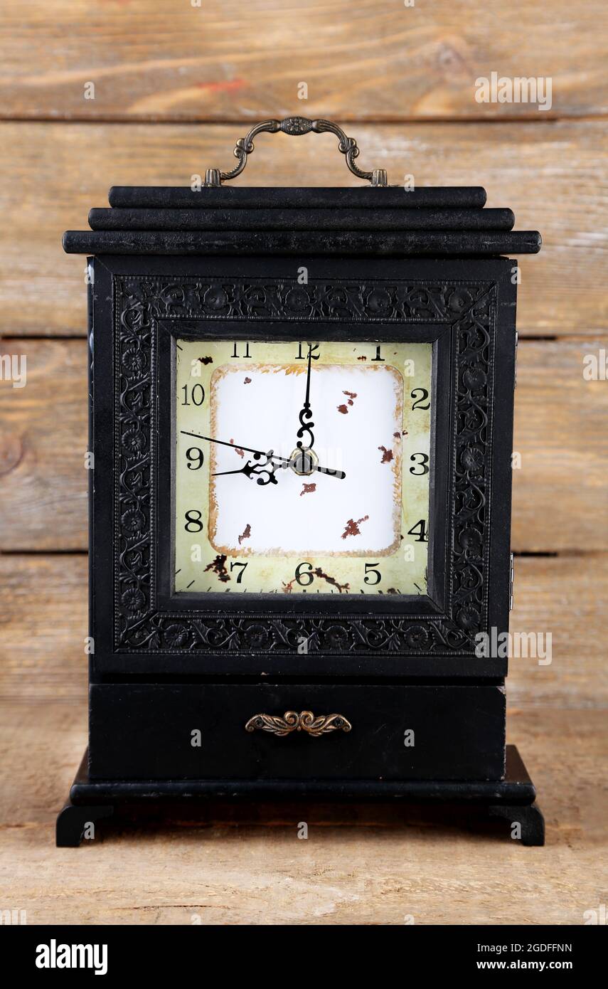 Old retro clock on wooden background Stock Photo - Alamy