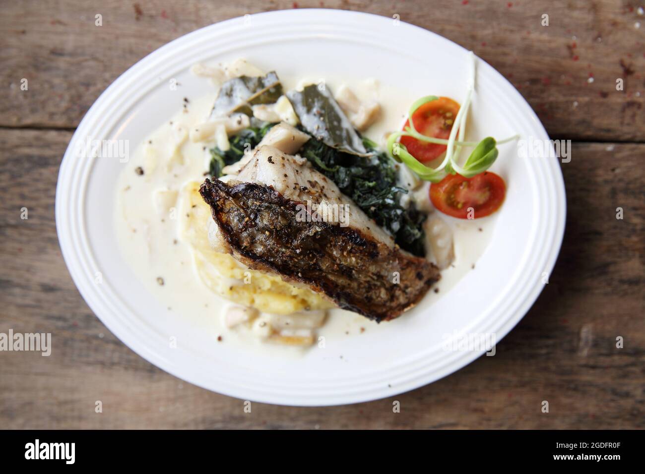 Grill sea bass fillets with crushed potatoes Stock Photo