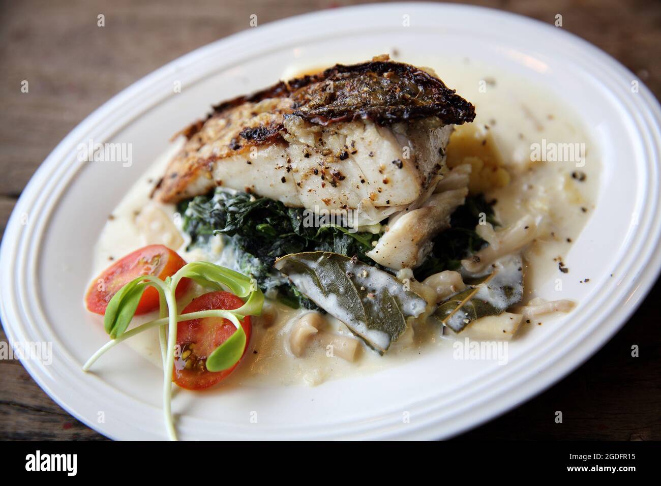Grill sea bass fillets with crushed potatoes Stock Photo