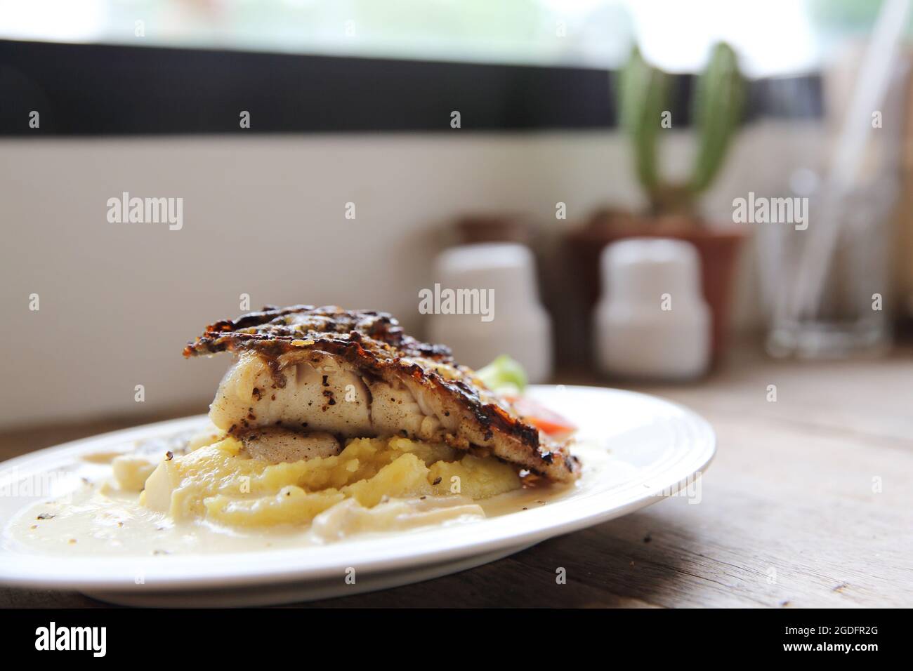 Grill sea bass fillets with crushed potatoes Stock Photo