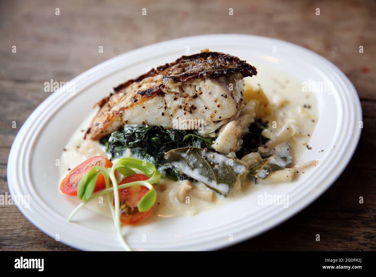 Grill sea bass fillets with crushed potatoes Stock Photo