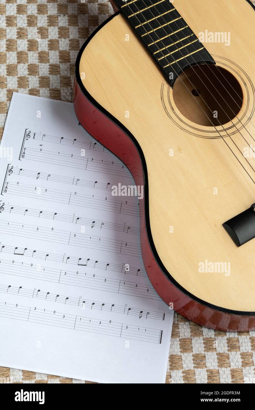 Classical guitar together with a sheet music Stock Photo
