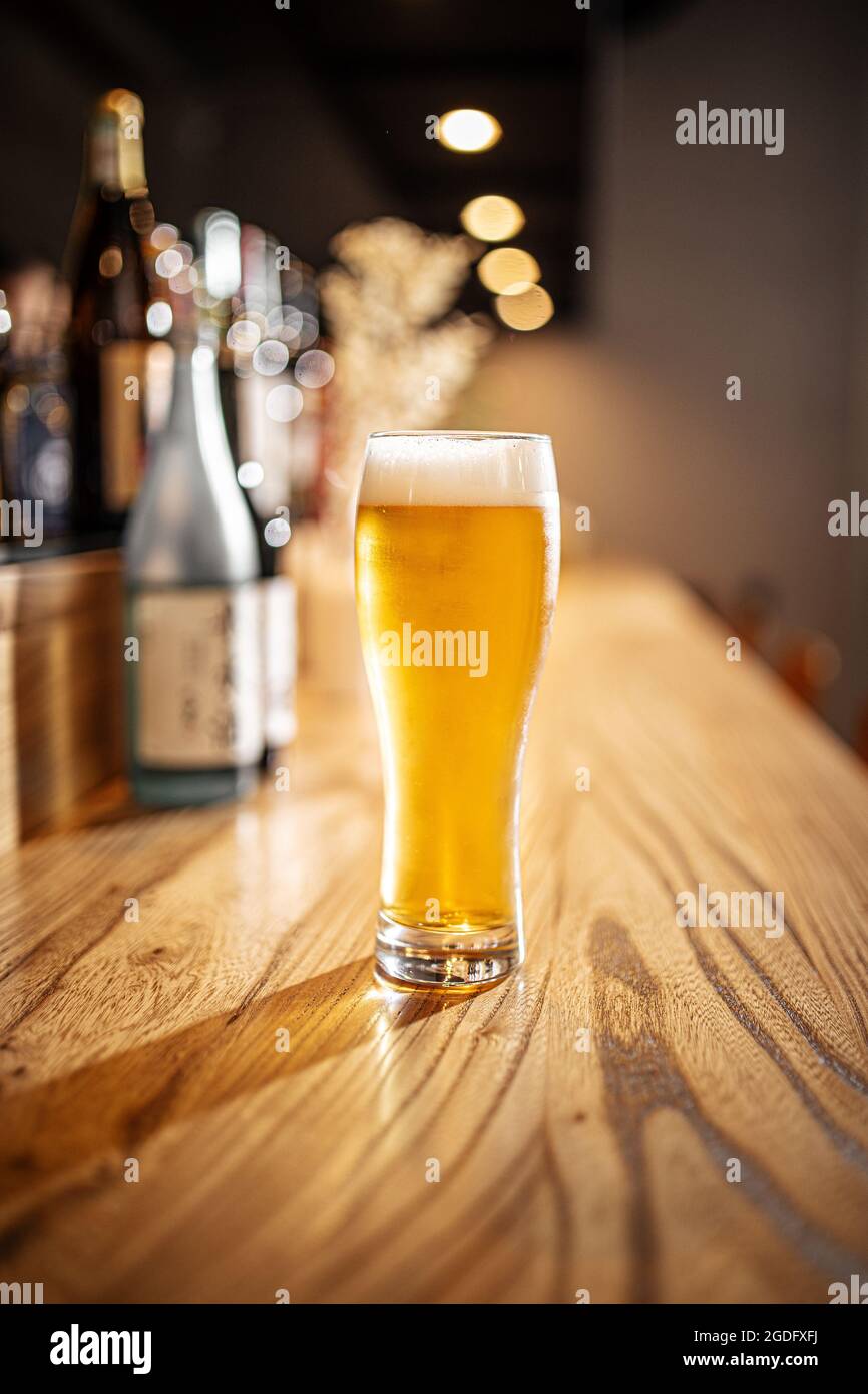Glass of japanese light beer on a bar desk Stock Photo