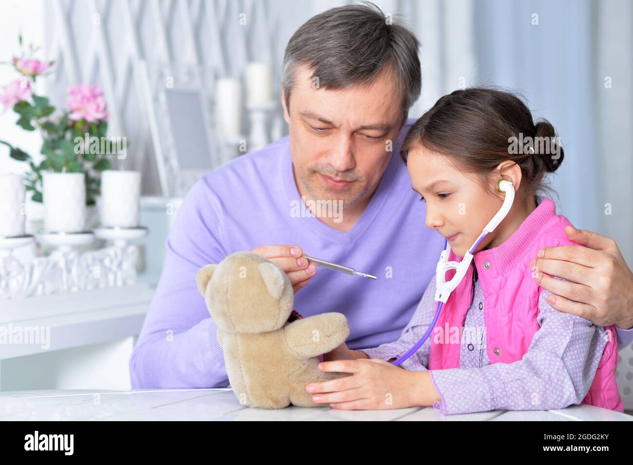 Close up portrait of cute little girl playing nurse Stock Photo - Alamy