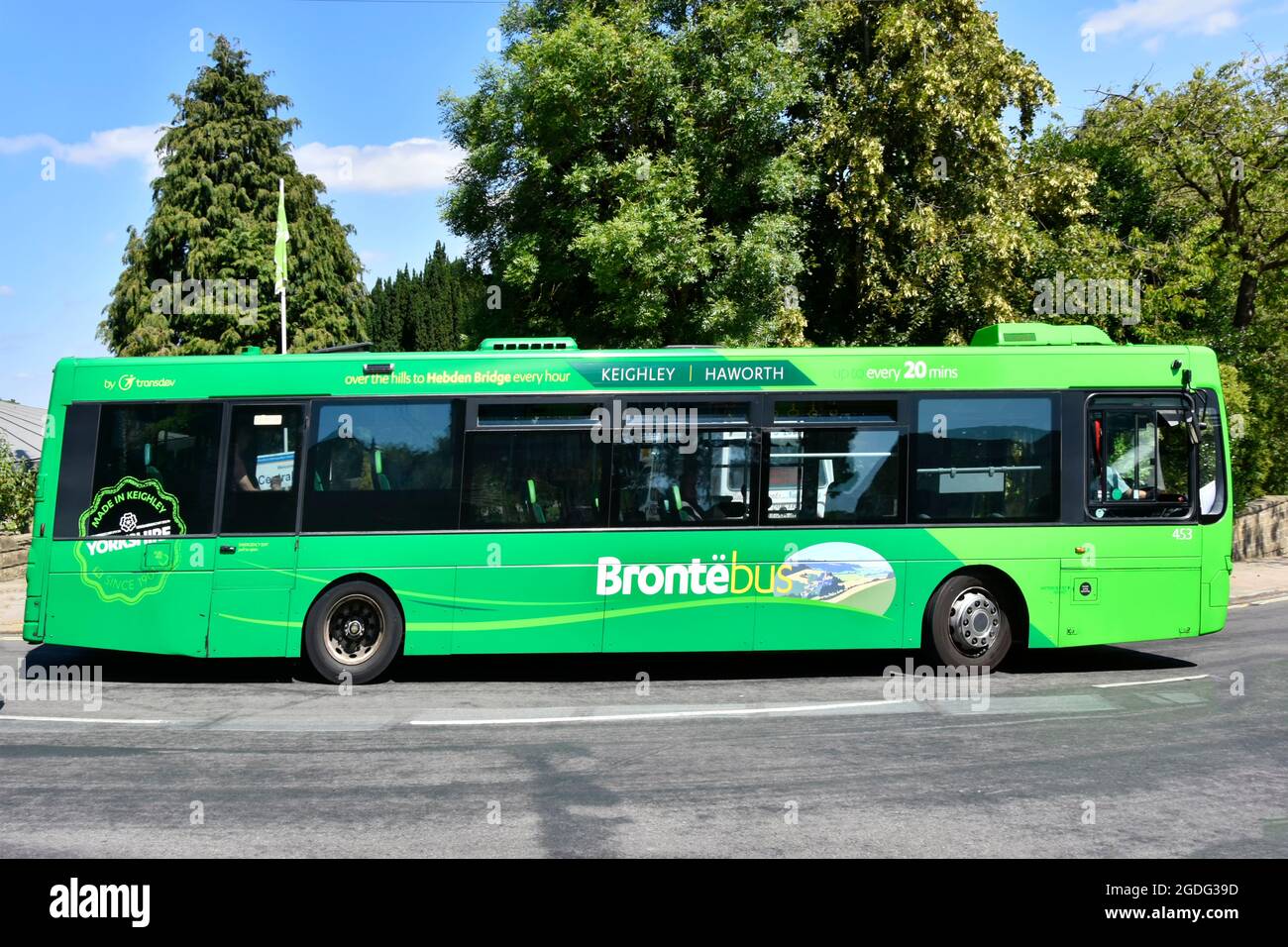 Side view graphics on Green single deck Bronte Bus operated by Transdev transport bottom end of Main Street hill in Haworth West Yorkshire, England UK Stock Photo