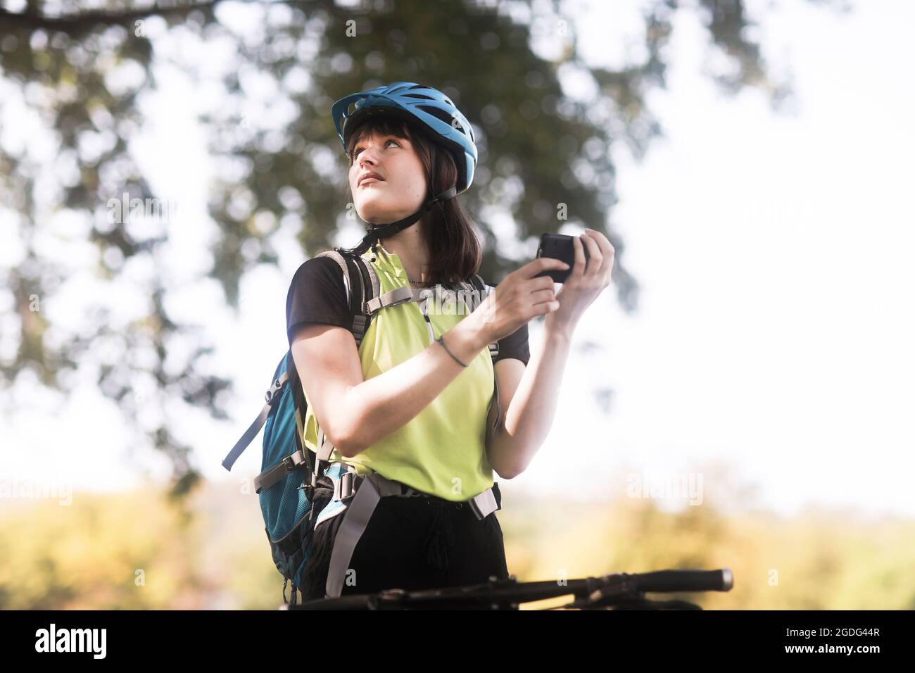 Biker stopping in park Stock Photo