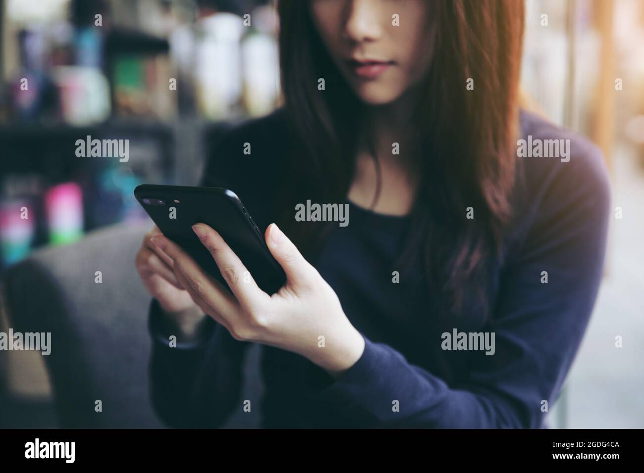 Asian female with hands typing text message Stock Photo - Alamy
