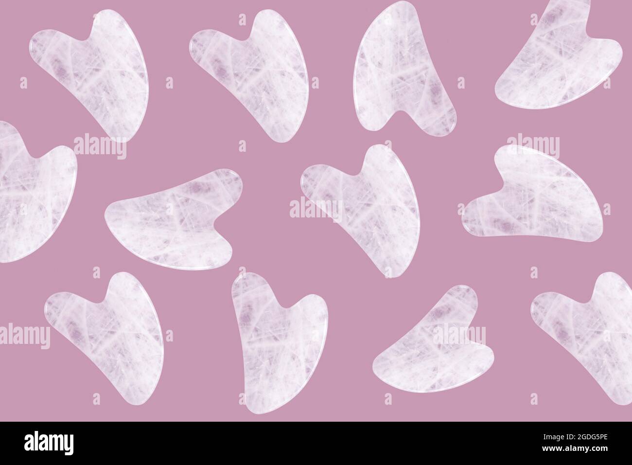 Pattern of pink jade guasha massagers or natural stone scrapers Stock Photo