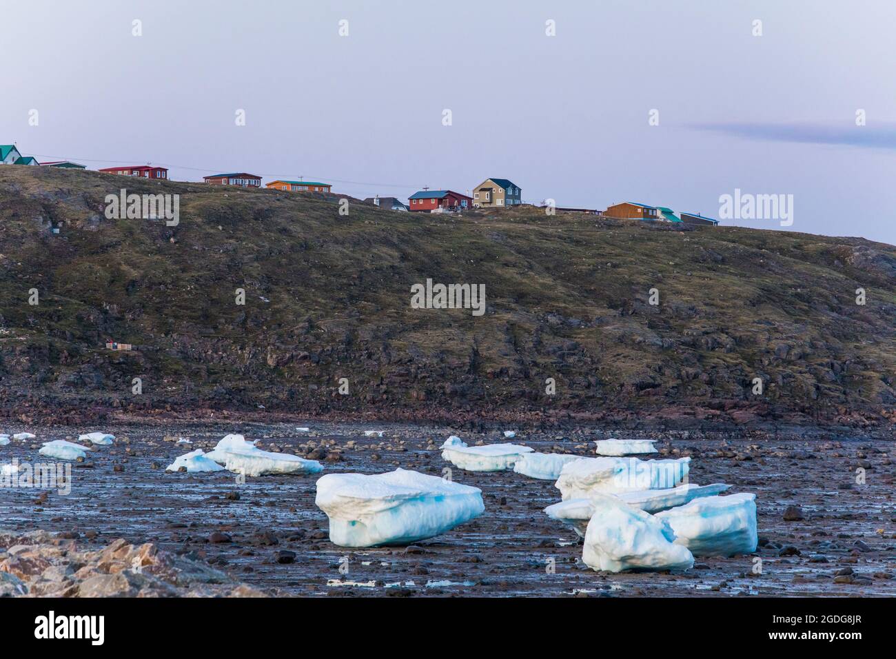 Homes built on cliff above the shoreline, city of iqaluit, Canada. Stock Photo