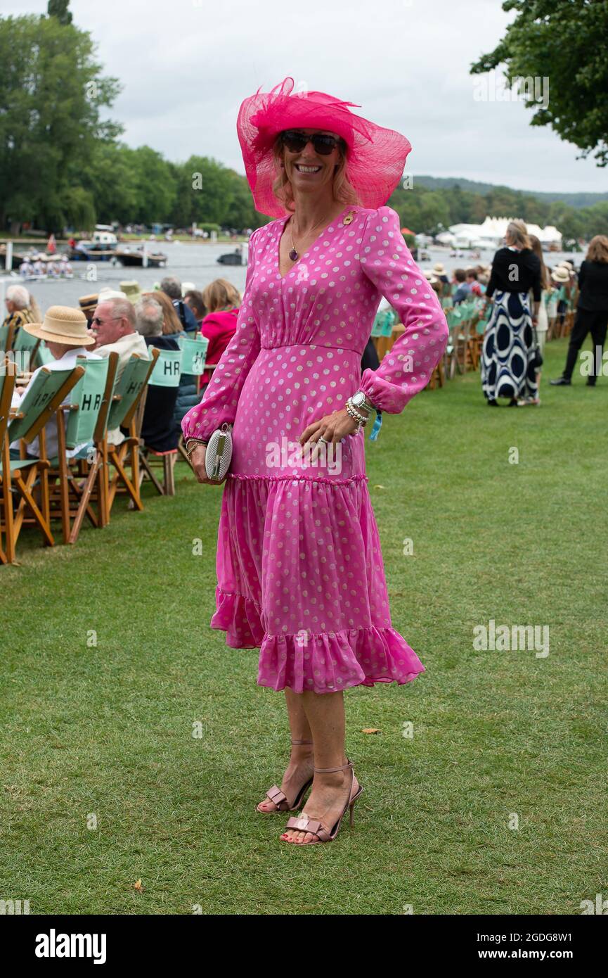 Henley-upon-Thames, Oxfordshire, UK. 13th August, 2021. A guest wears an  elegant floaty pink dress and pink hat. Henley Royal Regatta was in full  swing again today on day three. Guests were enjoying