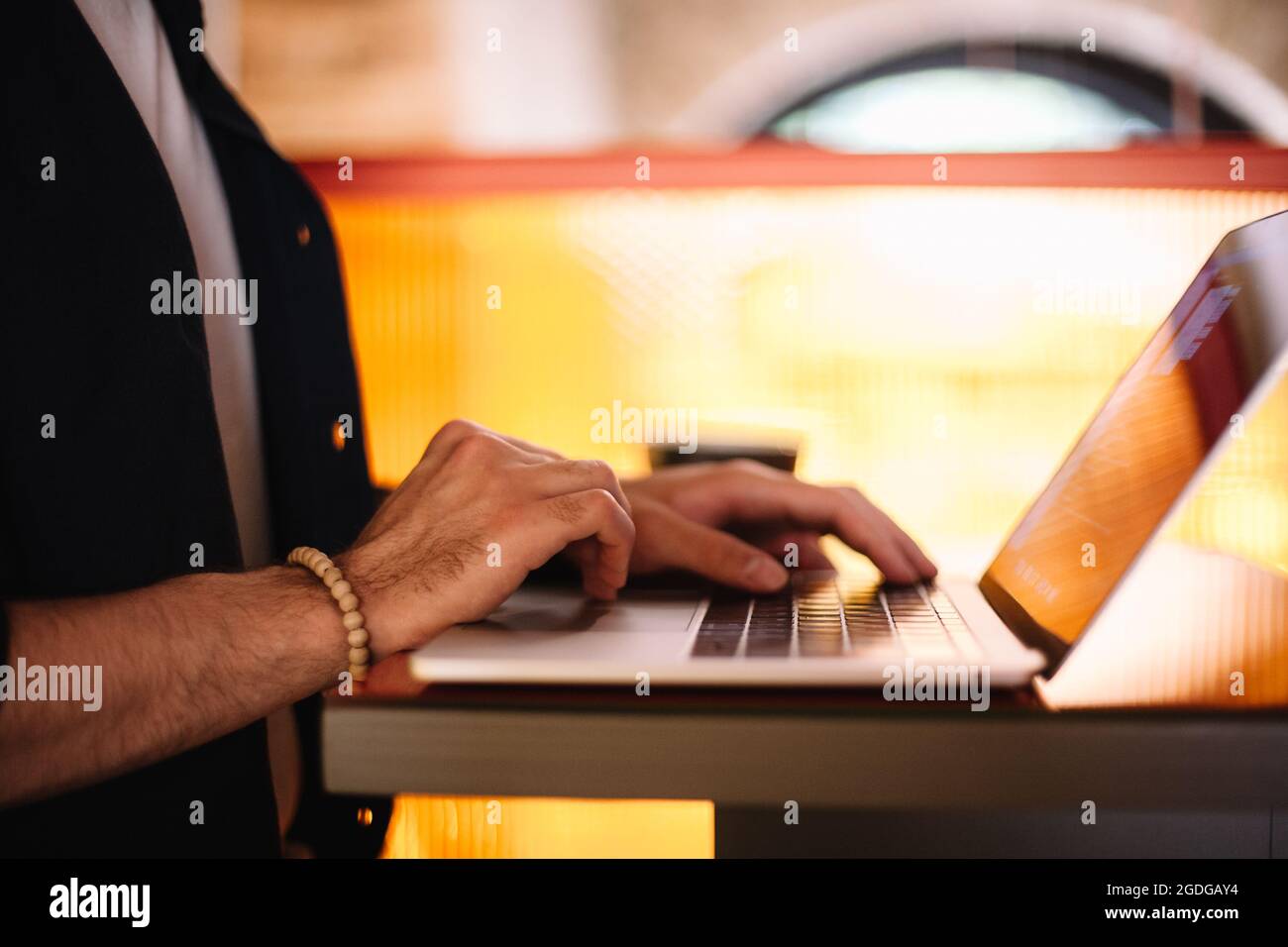 Man using laptop computer at cafe Stock Photo