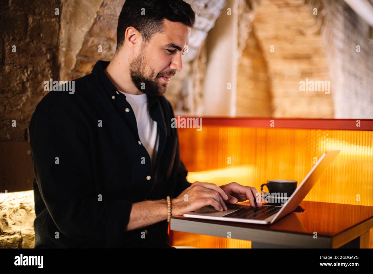 Happy businessman using laptop computer at cafe Stock Photo