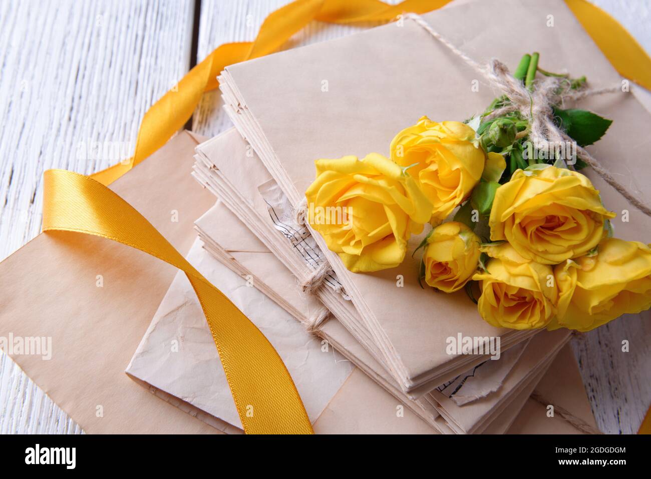 Old letters and flowers on wooden background close-up Stock Photo - Alamy