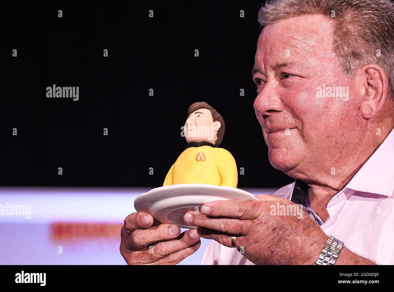 Actor William Shatner, best known for his portrayal of Captain James T. Kirk of the USS Enterprise in the Star Trek television series and movies, holds a portion of a birthday cake presented to him at a Q&A session on the opening day of MEGACON at the Orange County Convention Center. The 4-day convention caters to the comic book, sci-fi, anime, fantasy, and gaming communities, and features celebrity appearances. Due to the current spike in COVID-19 cases in Florida, all attendees are required to wear face masks. Stock Photo