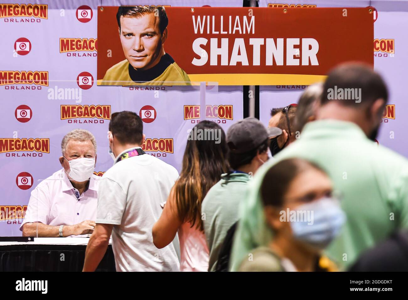 Orlando, United States. 12th Aug, 2021. Actor William Shatner, best known for his portrayal of Captain James T. Kirk of the USS Enterprise in the Star Trek television series and movies, signs autographs for fans on the opening day of MEGACON at the Orange County Convention Center. The 4-day convention caters to the comic book, sci-fi, anime, fantasy, and gaming communities, and features celebrity appearances. Due to the current spike in COVID-19 cases in Florida, all attendees are required to wear face masks. Credit: SOPA Images Limited/Alamy Live News Stock Photo