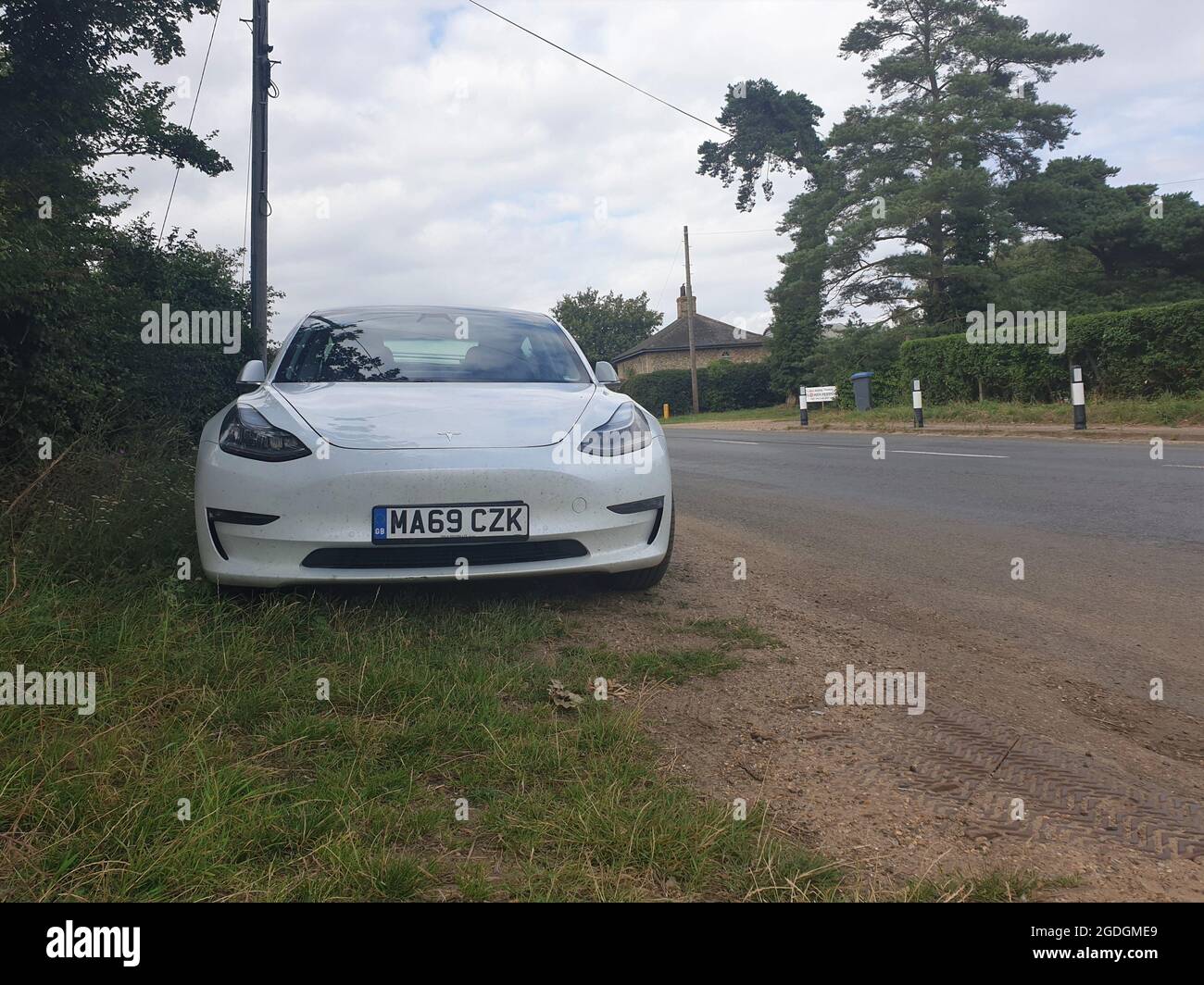 Sutton Suffolk UK August 12 2021: A 2019 model Tesla Model 3 Long-Range Dual Motor AWD electric vehicle parked in a small countryside village in Suffo Stock Photo