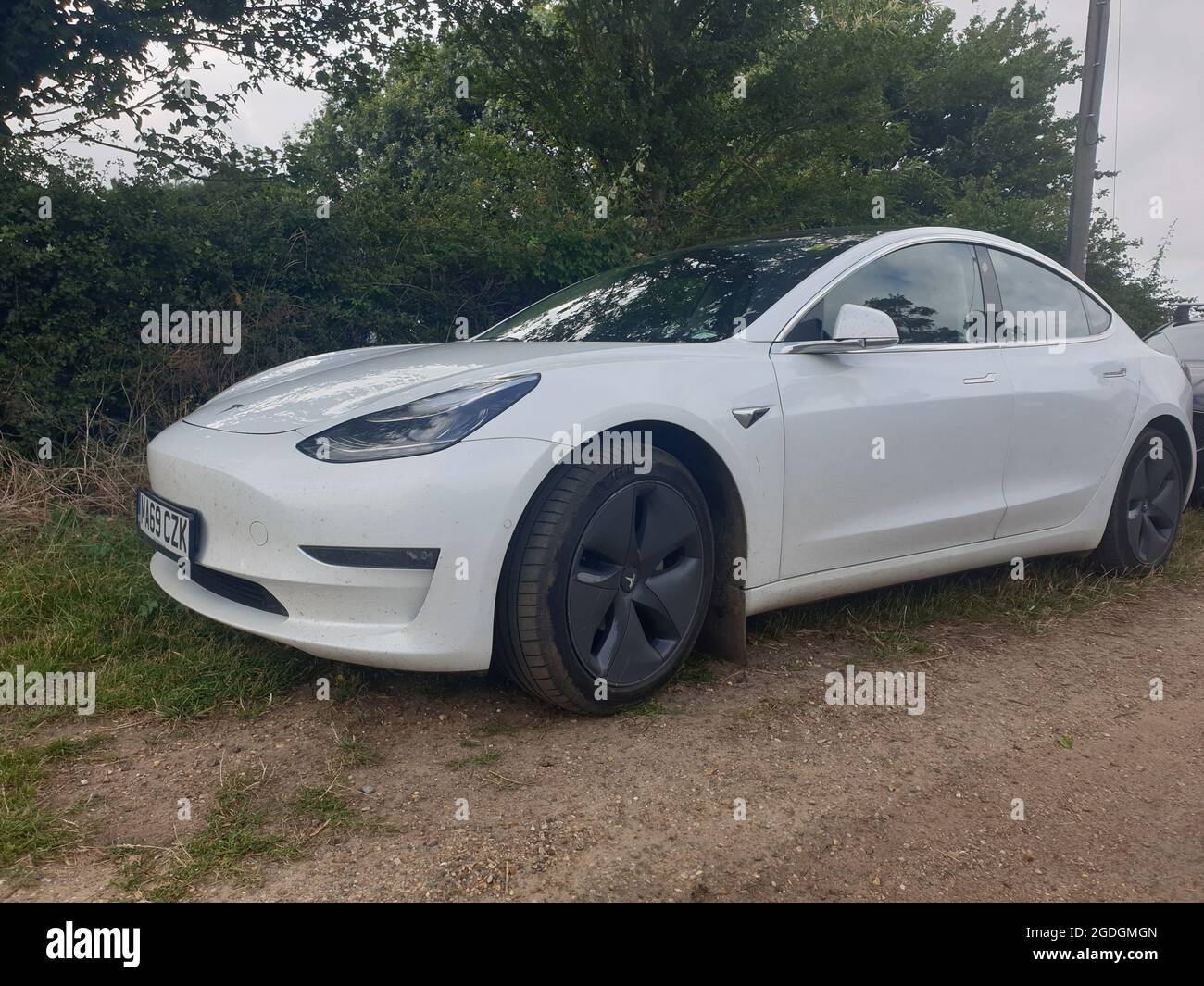 Sutton Suffolk UK August 12 2021: A 2019 model Tesla Model 3 Long-Range Dual Motor AWD electric vehicle parked in a small countryside village in Suffo Stock Photo