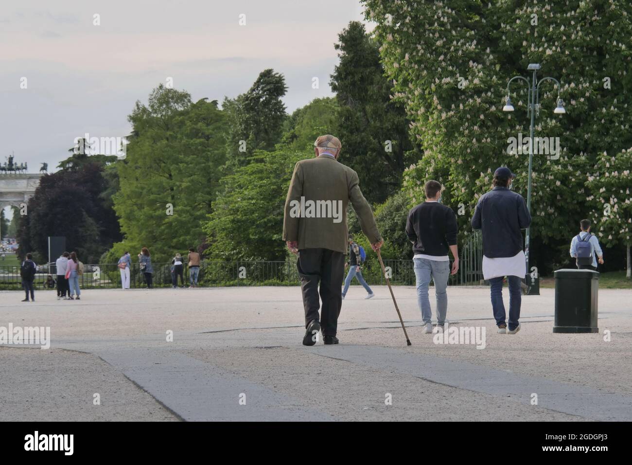Old man walking with his cane in public park Stock Photo - Alamy