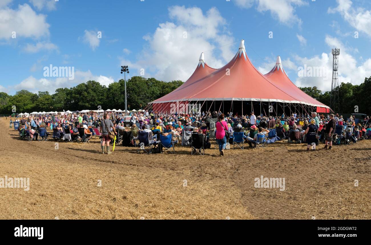 Festival goers enjoy a live performance, the first in 2 years on the Wickham Festival Village stage, Wickham, UK. August 6, 2021 Stock Photo