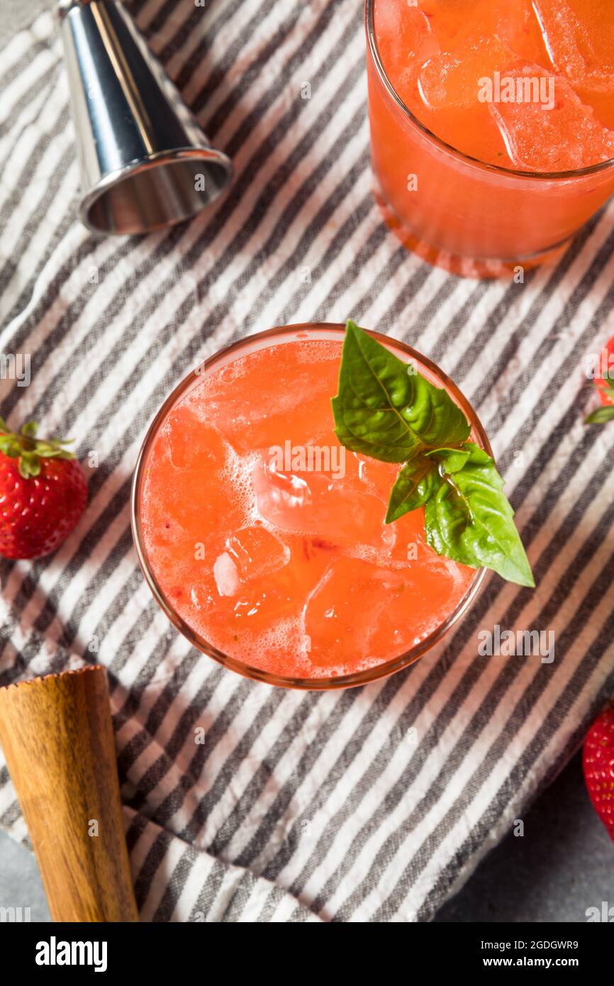 Boozy Refreshing Strawberry Basil Smash Cocktail with Gin Stock Photo