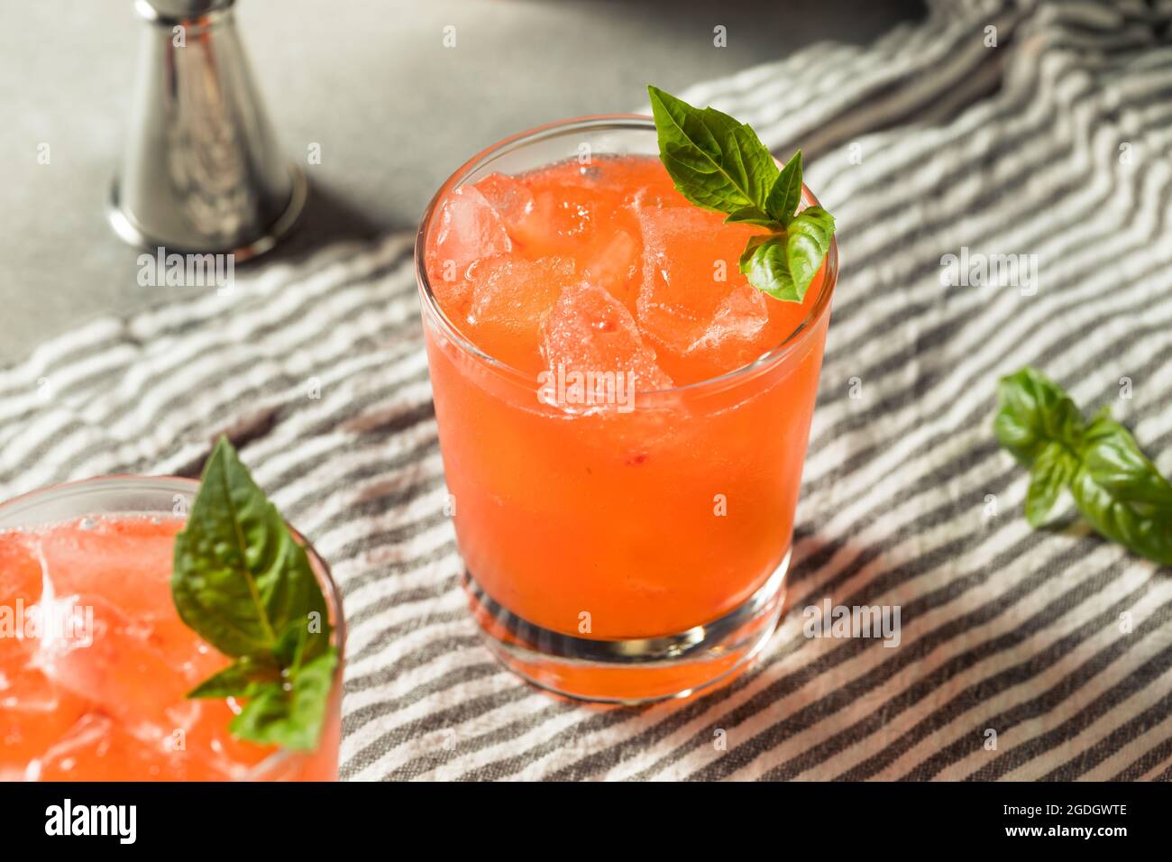 Boozy Refreshing Strawberry Basil Smash Cocktail with Gin Stock Photo
