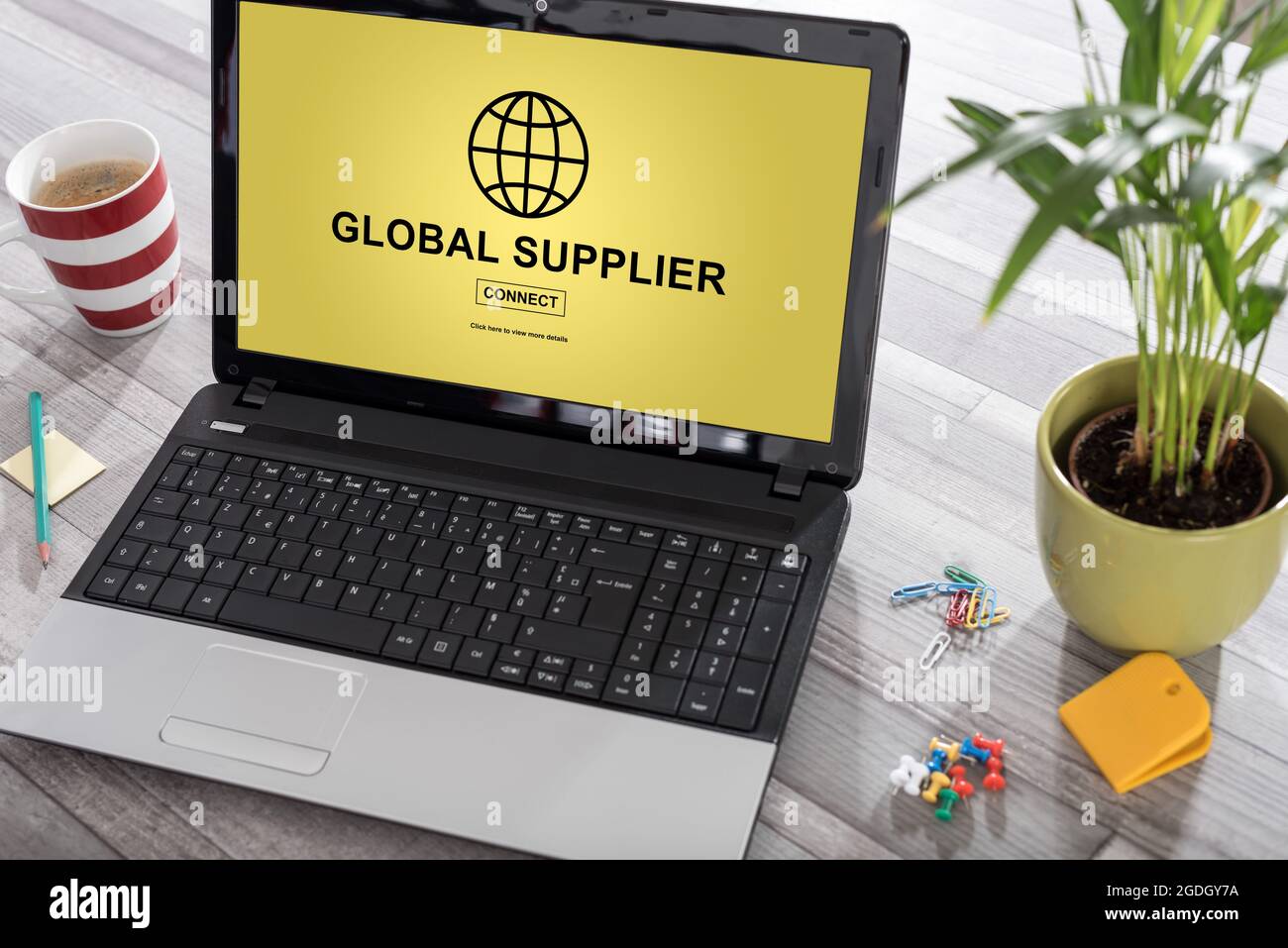 Laptop on a desk with global supplier concept on the screen Stock Photo