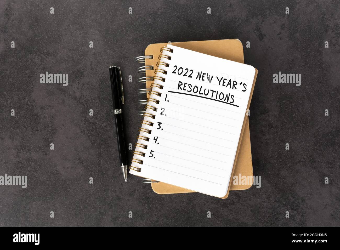 2022 New Year's Resolutions Text on Note Pad Stock Photo