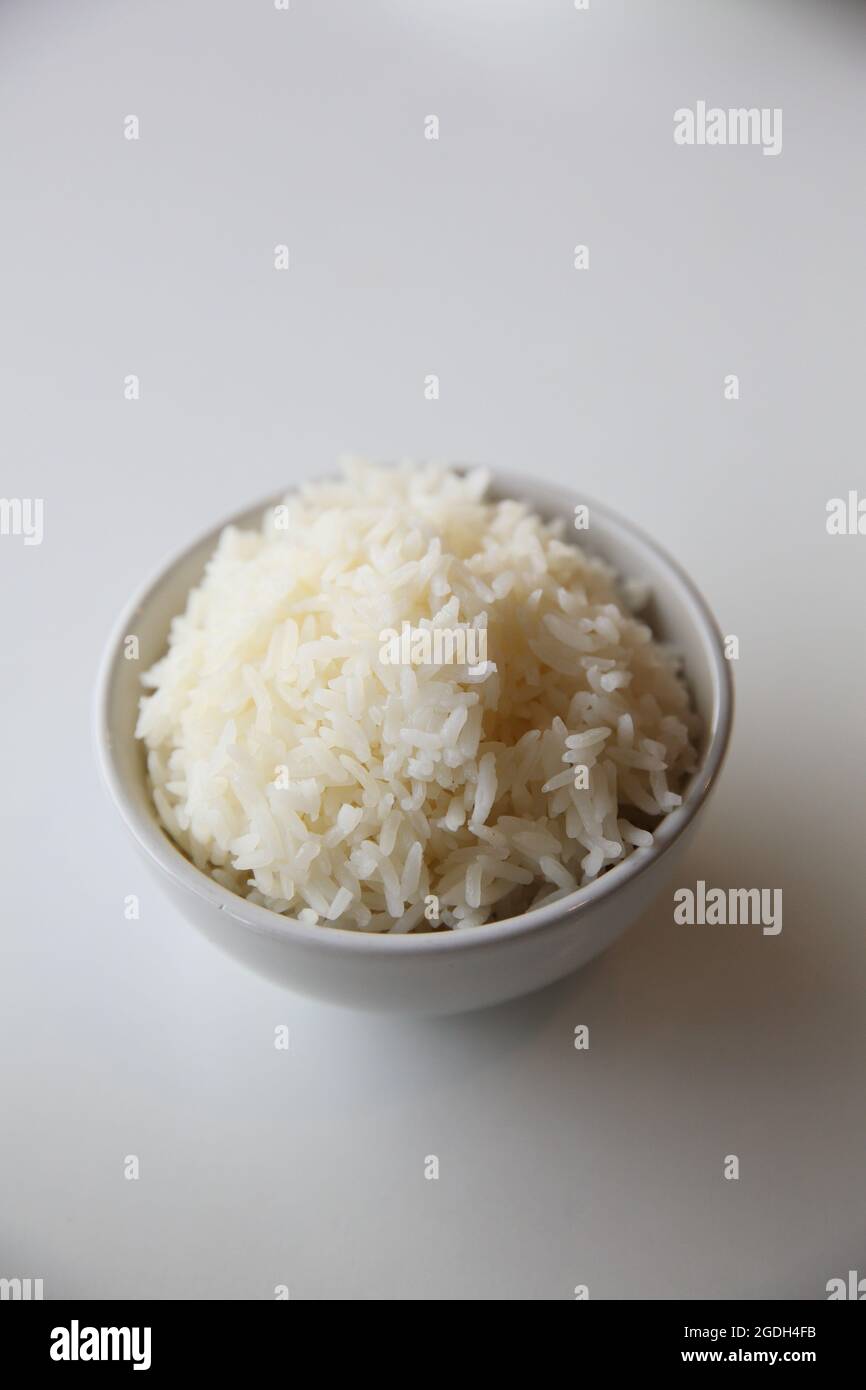 Cooked rice in bowl isolated in white background Stock Photo - Alamy