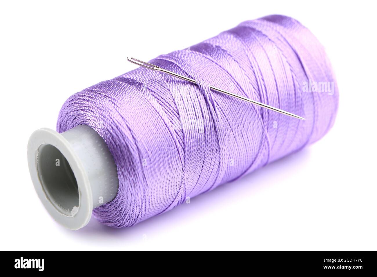 Needle and spool of thread isolated on white Stock Photo - Alamy