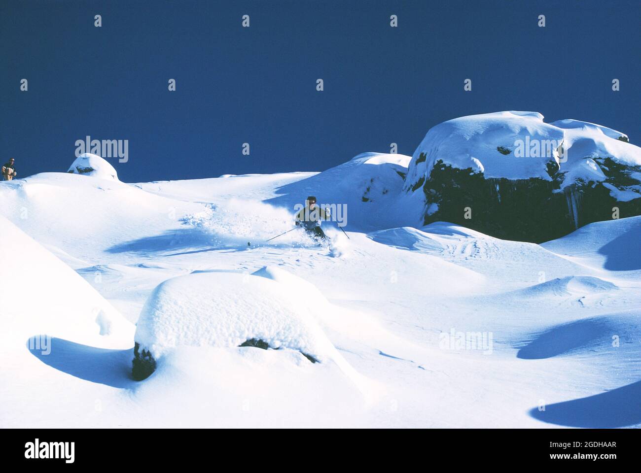 Australia. New South Wales. Perisher. Young man downhill skiing in powder snow. Stock Photo