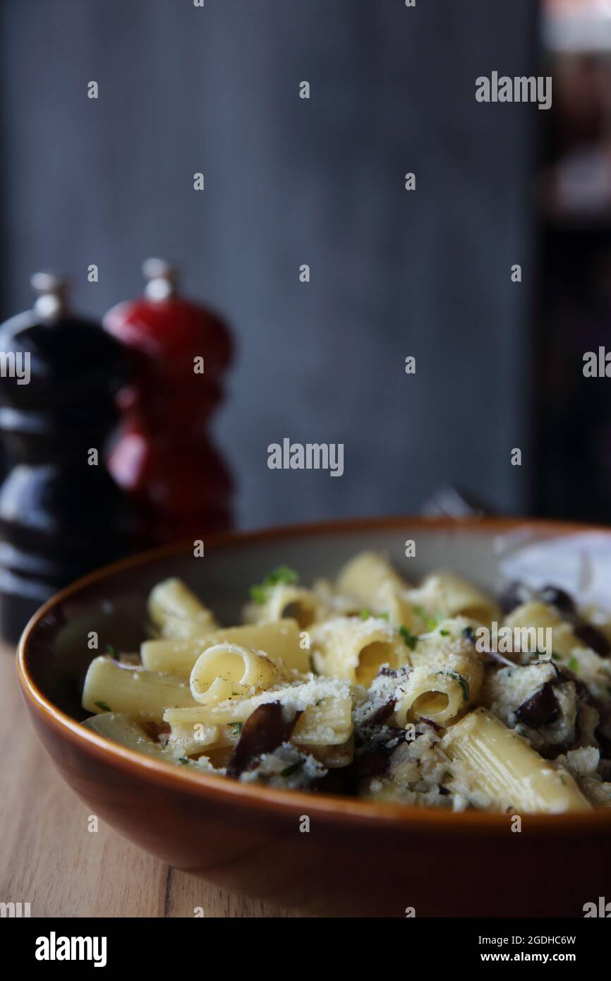pasta mushroom truffle oil on wood background , Rigatoni pasta noodle