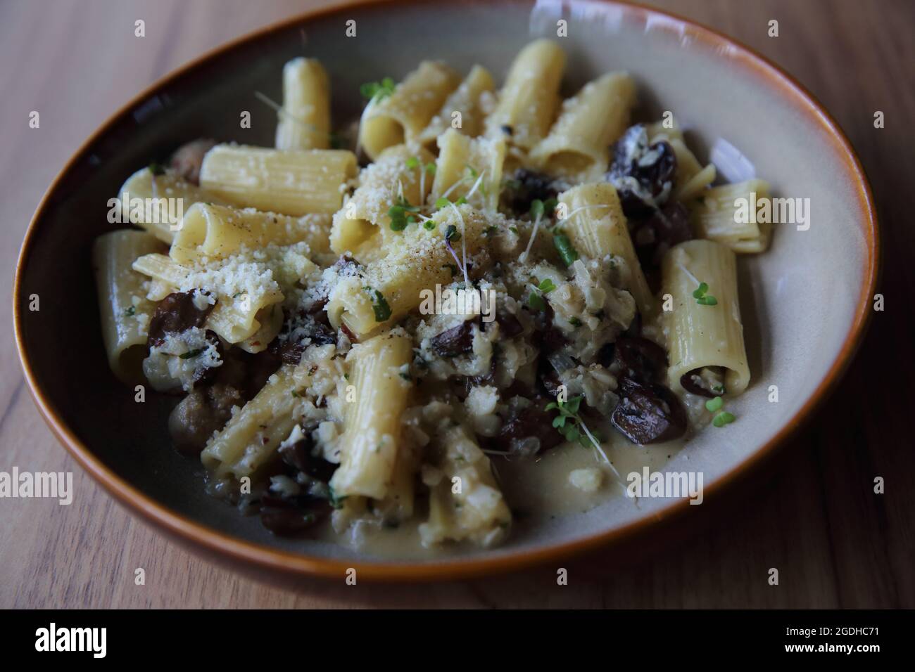 pasta mushroom truffle oil on wood background , Rigatoni pasta noodle
