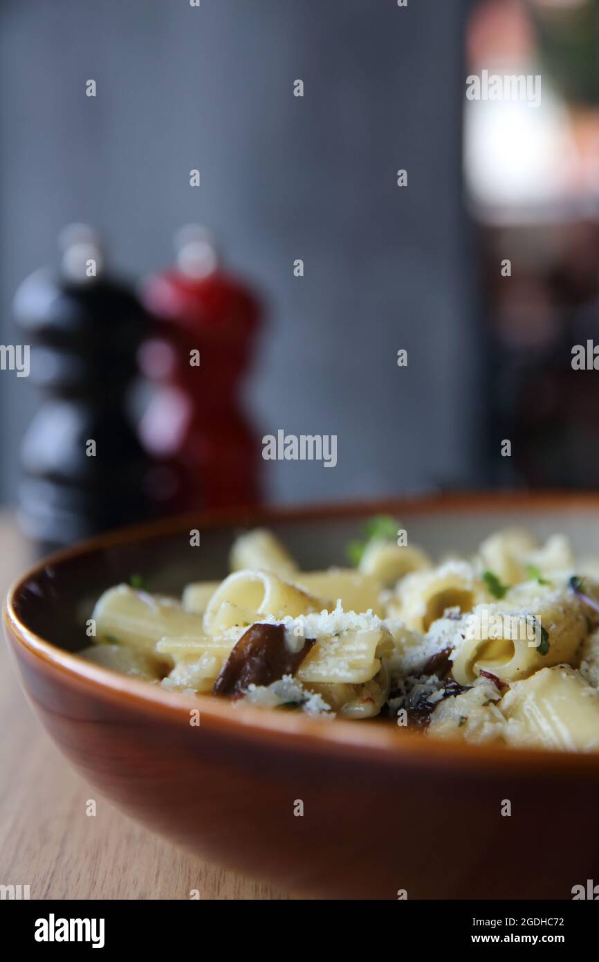 pasta mushroom truffle oil on wood background , Rigatoni pasta noodle