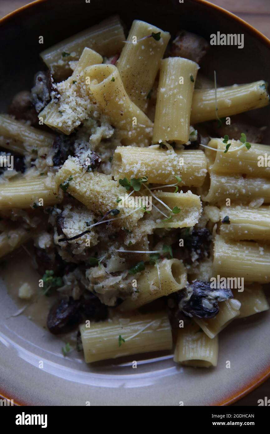 pasta mushroom truffle oil on wood background , Rigatoni pasta noodle