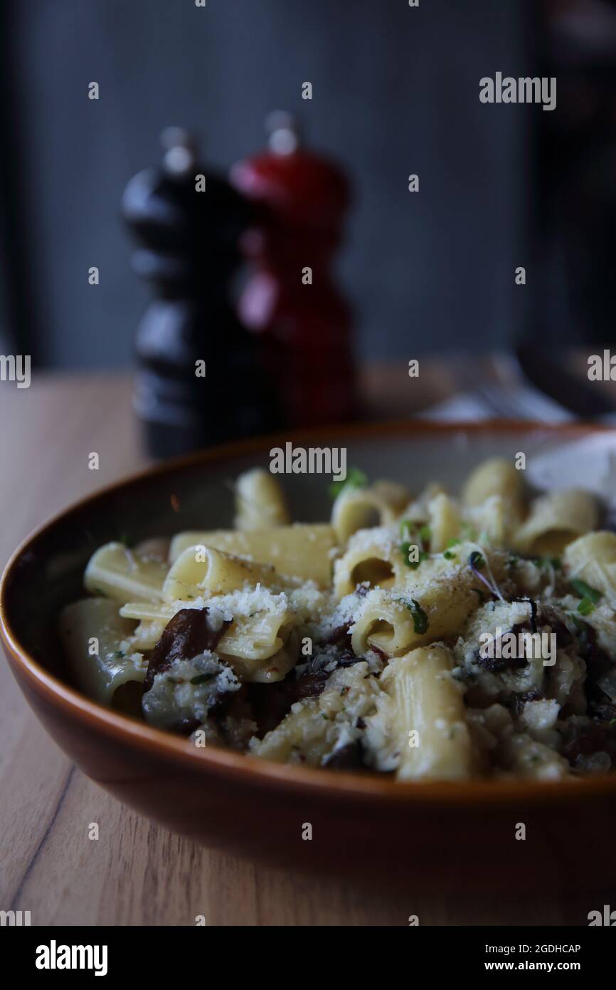 pasta mushroom truffle oil on wood background , Rigatoni pasta noodle