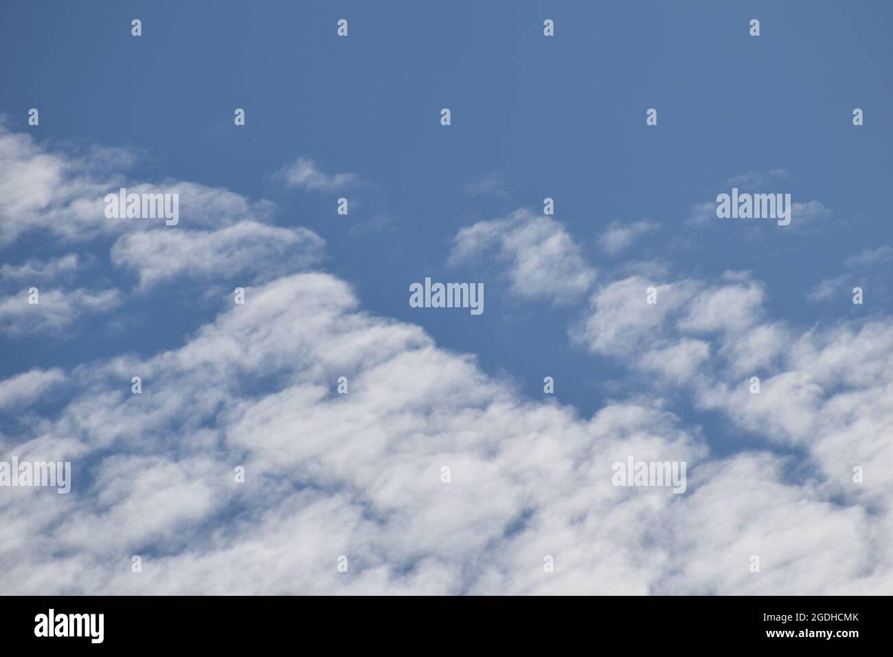 Fluffy white clouds in a blue sky Stock Photo