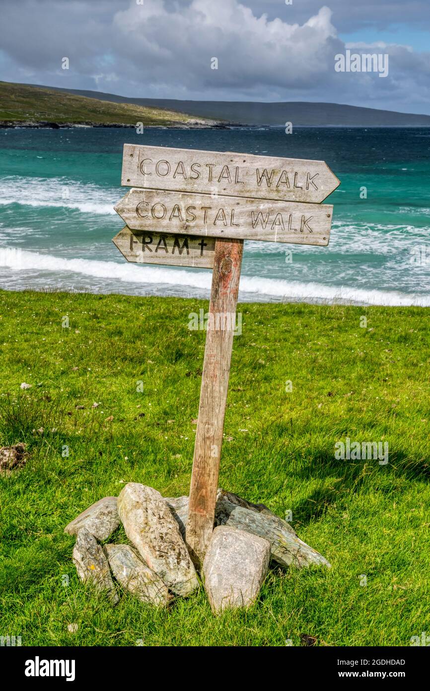 A signpost for the Coastal Walk beside deseerted Sandwick beach on Unst, Shetland. Stock Photo