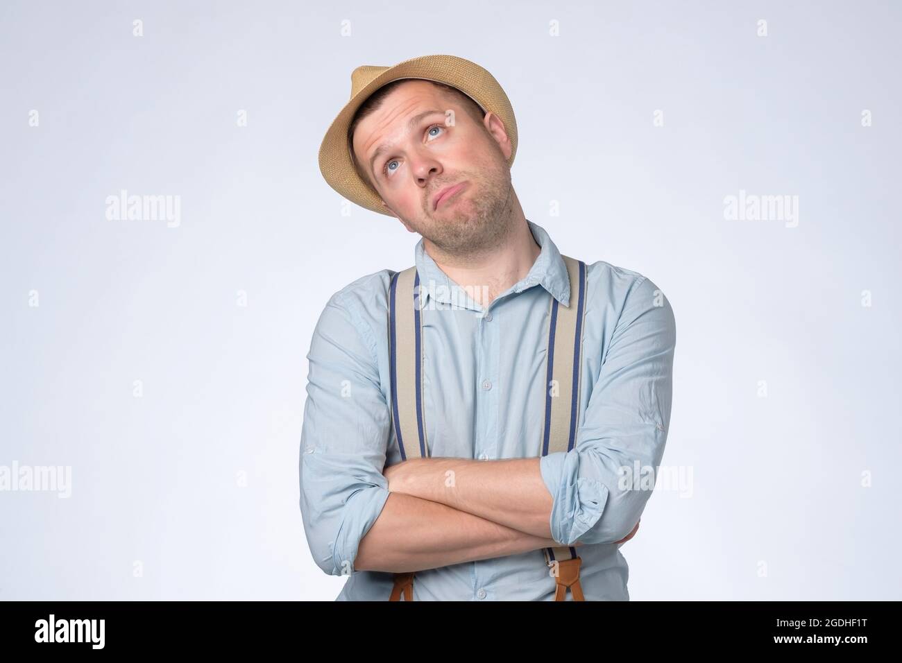 Young thoughtful man looking up generating idea, making plans for future. Stock Photo