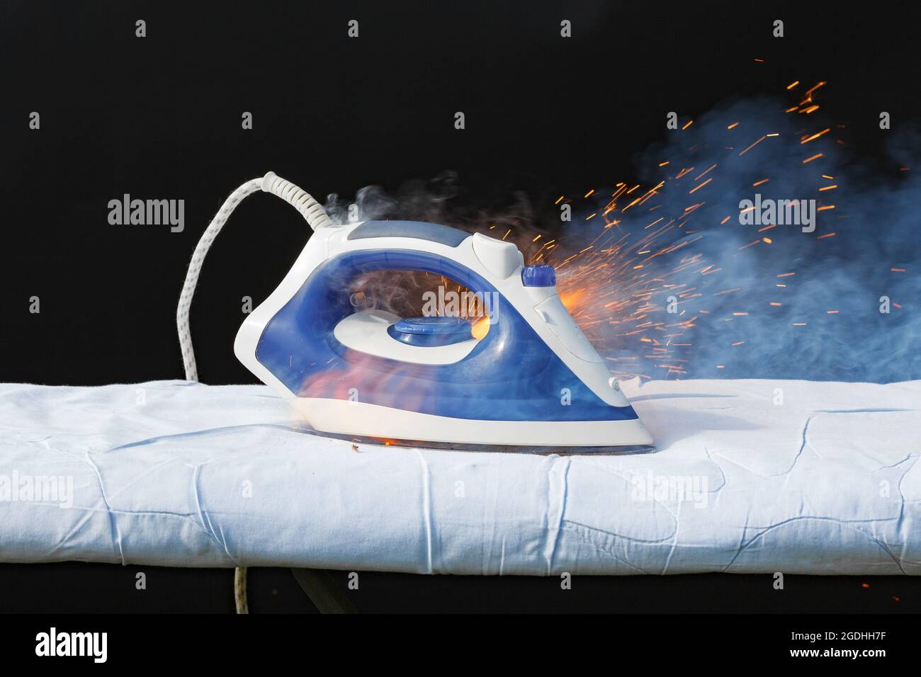 Iron in flames of fire, faulty wiring, cause of fire Stock Photo Alamy