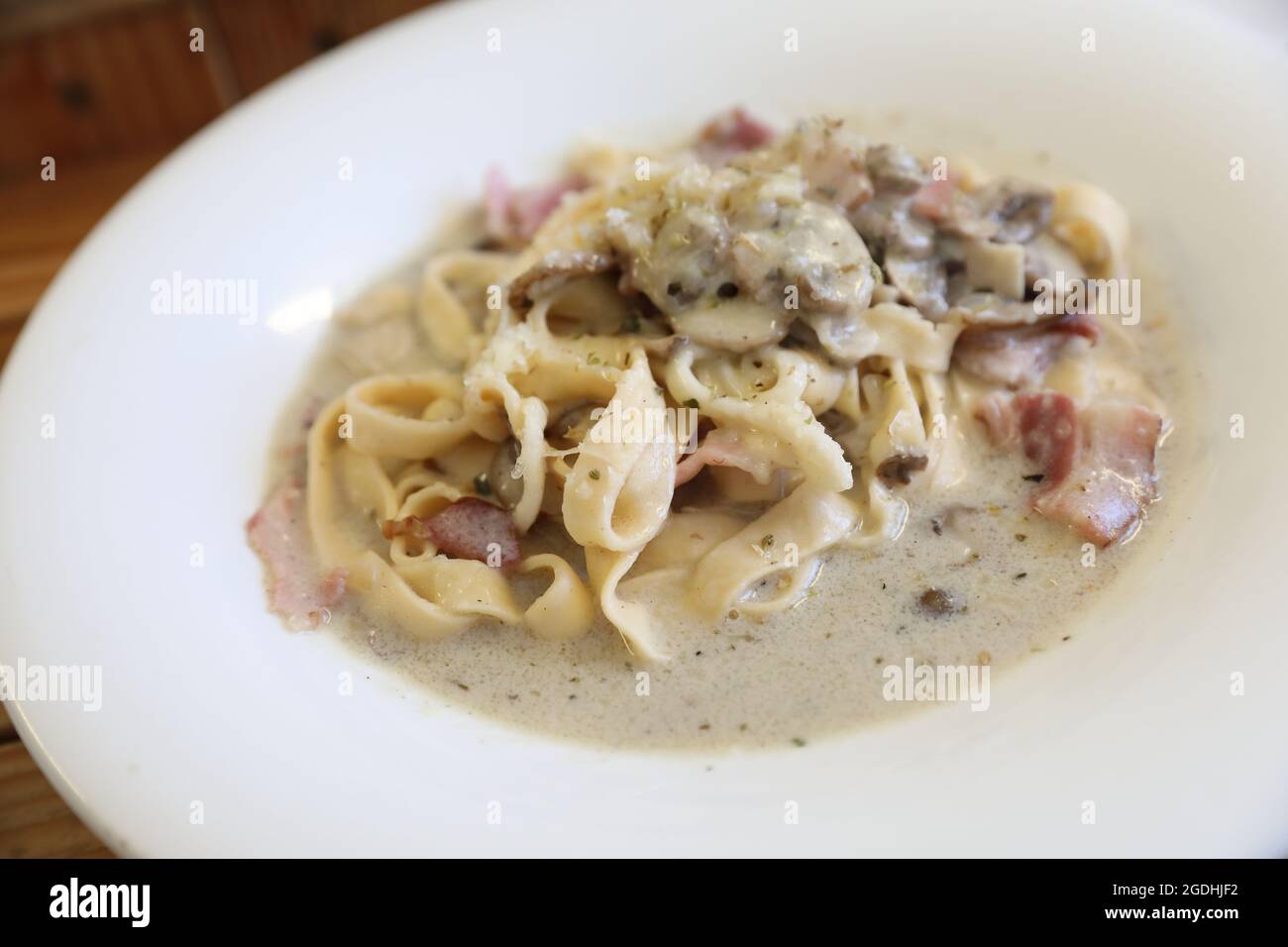 pasta fettuccine alfredo white sauce with ham bacon and mushroom Stock Photo Alamy