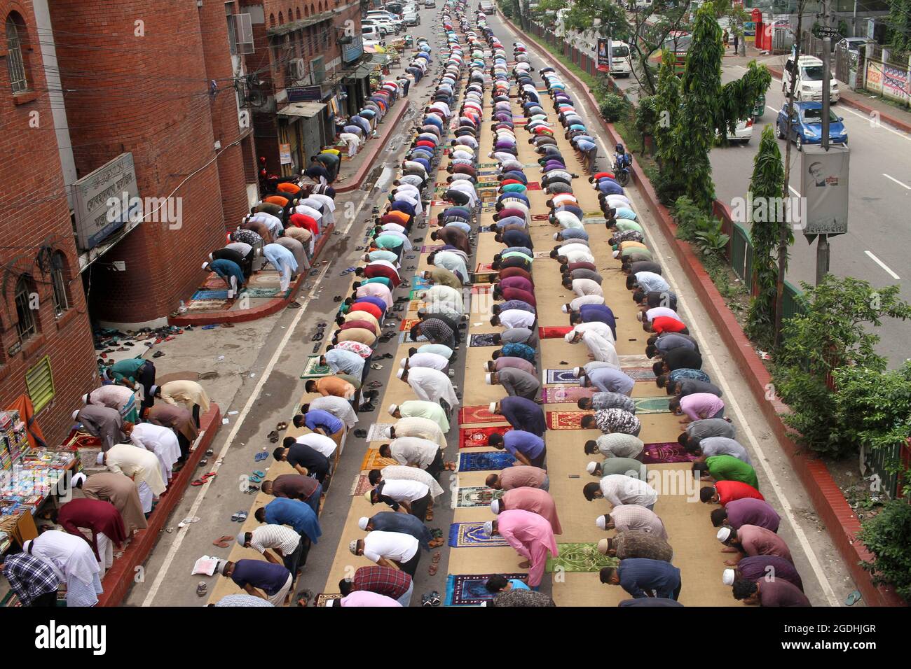 Dhaka, Bangladesh. 13th Aug, 2021. Aerial view of thousands of Muslims meeting take part during a mass Jummah Prayer, Due this Islamic ritual is mandatory act, it is performed every Friday to fulfill its obligations as a faithful. Jummah is the holiest day of the week on which special congregational prayers are offered. Fridays are considered a celebration in their own right and Muslims take special care in wearing clean clothes, bathing, and preparing special meals on this day. (Photo by Eyepix Group/Pacific Press) Credit: Pacific Press Media Production Corp./Alamy Live News Stock Photo