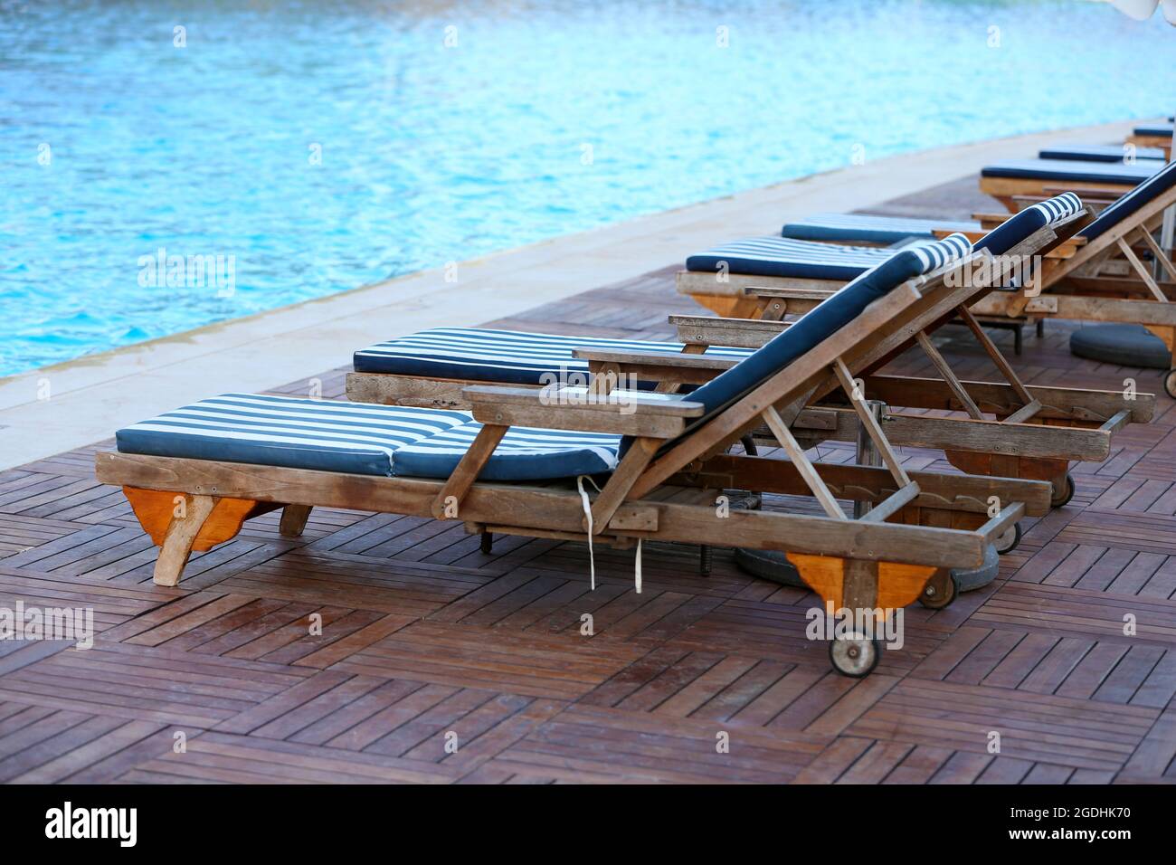 Lounge sunbeds near swimming pool Stock Photo Alamy
