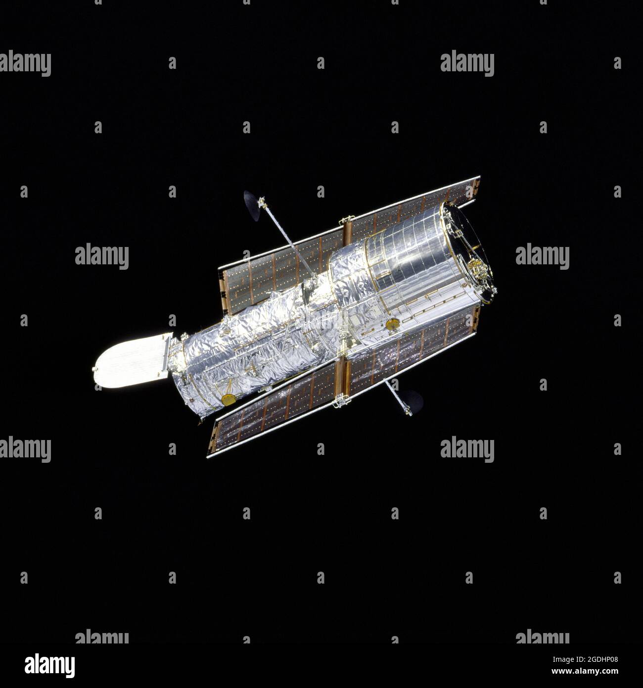 The Hubble Space Telescope (HST) in orbit against the blackness of space Stock Photo
