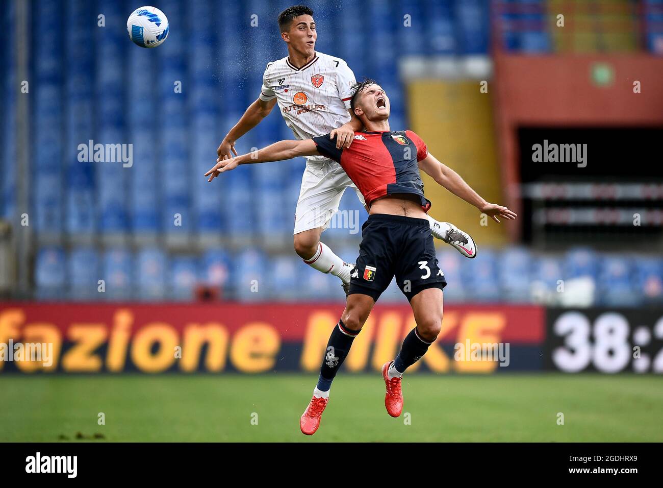 Genoa, Italy. 13 August 2021. Samuele Righetti (L) of AC Perugia competes for a header with Zinho Vanheusden of Genoa CFC during the Coppa Italia football match between Genoa CFC and AC Perugia. Credit: Nicolò Campo/Alamy Live News Stock Photo