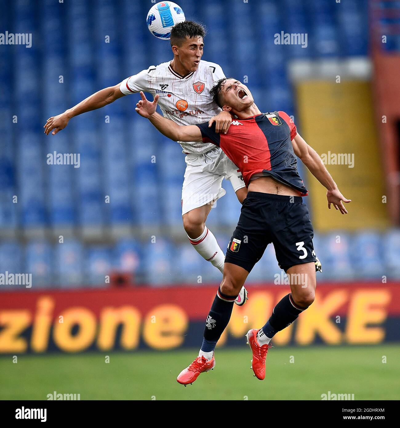 Genoa, Italy. 13 August 2021. Samuele Righetti (L) of AC Perugia competes for a header with Zinho Vanheusden of Genoa CFC during the Coppa Italia football match between Genoa CFC and AC Perugia. Credit: Nicolò Campo/Alamy Live News Stock Photo