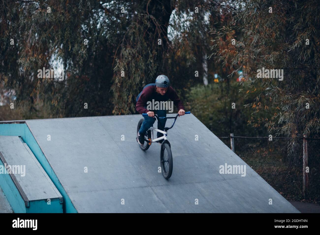 Professional young sportsman cyclist riding mini bike at skatepark ...