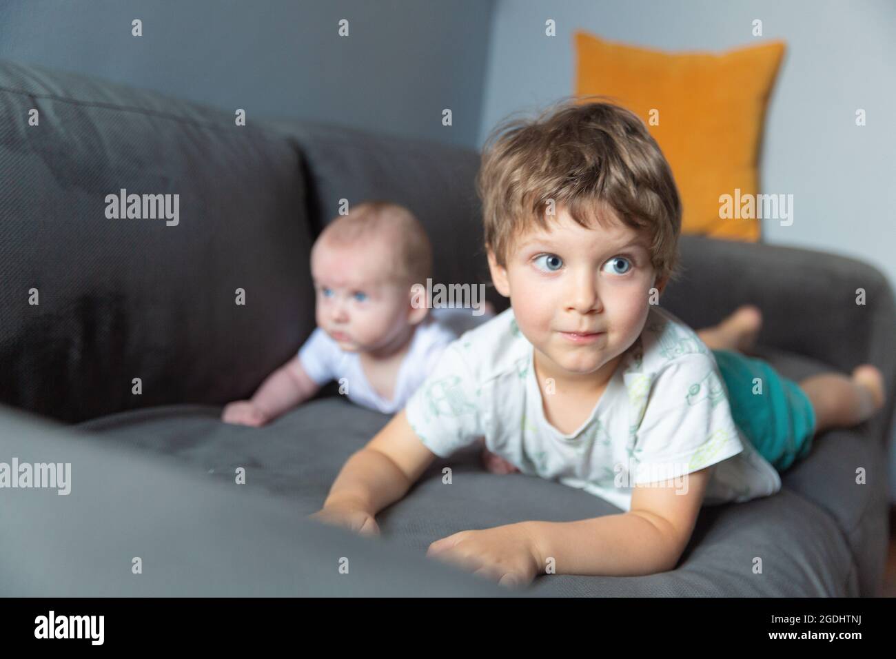 Two boys lying on the sofa Stock Photo